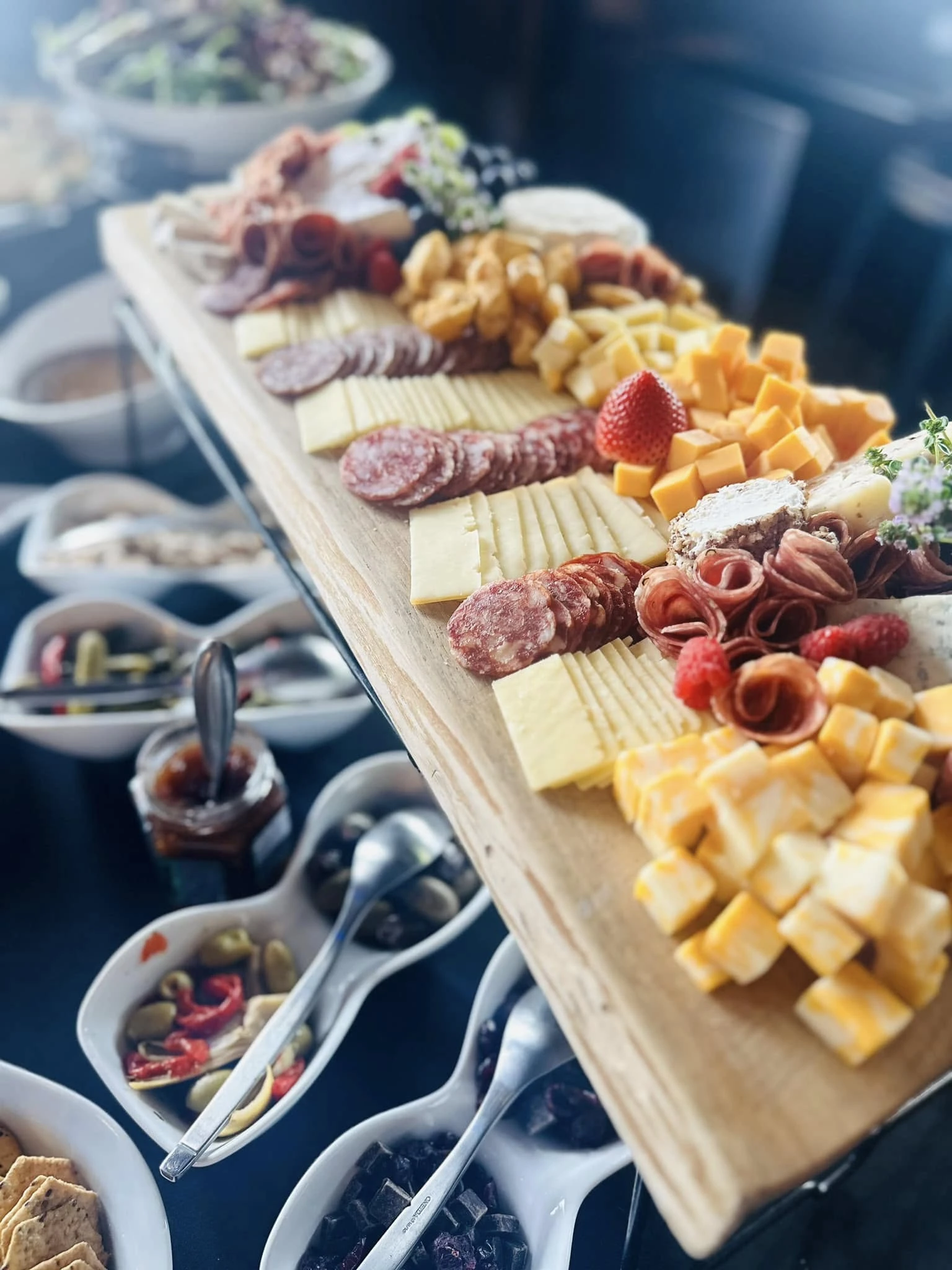 A grazing board with cheeses, meats, crackers, and accompaniments